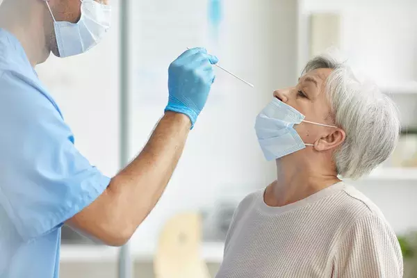 A doctor administering a nasal swab